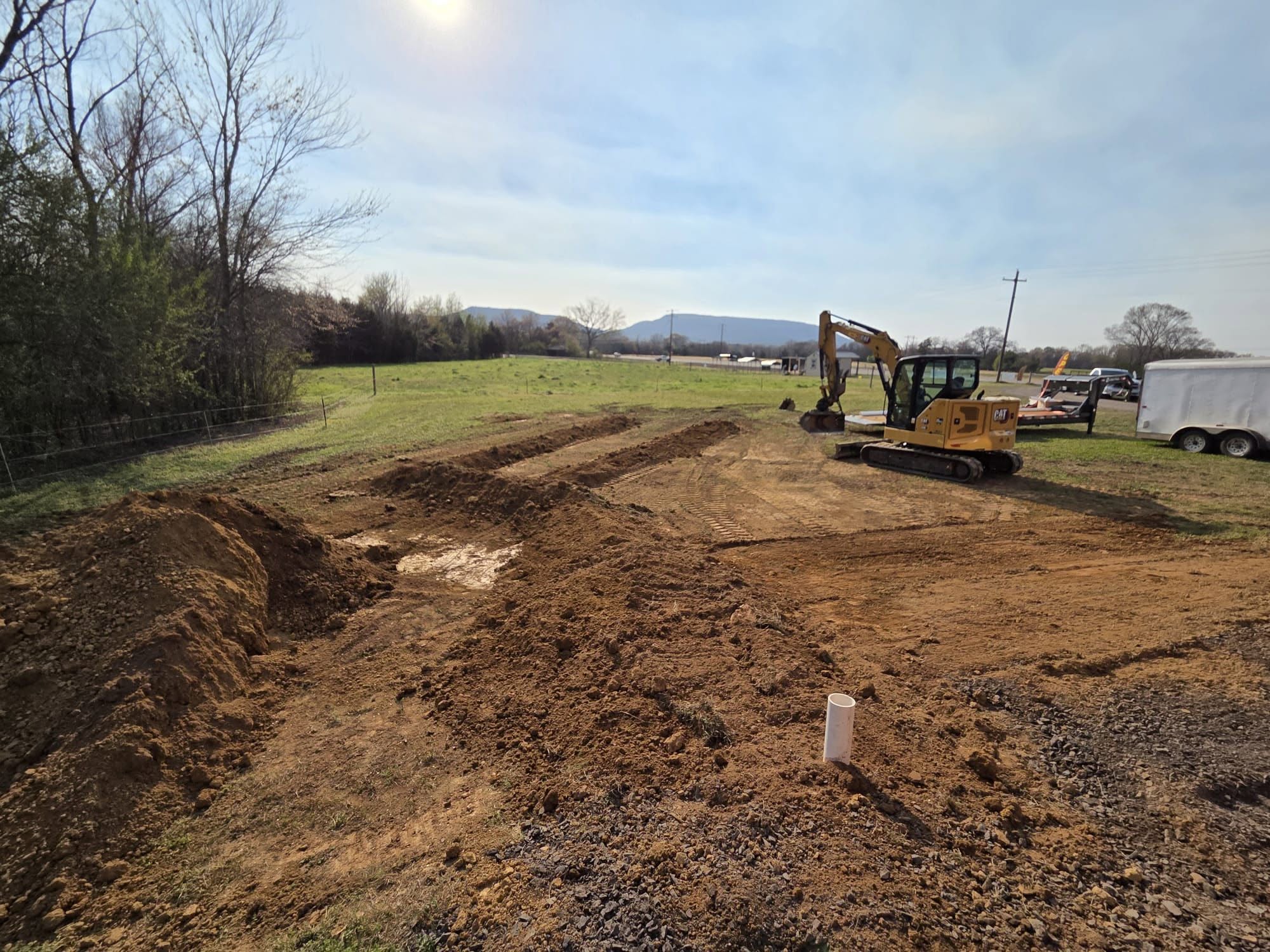 Excavator grading a dirt site
